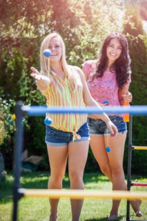Portrait of young women throwing balls