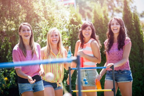Portrait of young women throwing balls