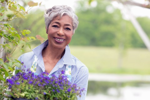 Portrait of senior woman working in garden