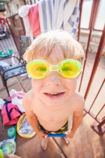 Boy (4-5) posing in swimming goggles