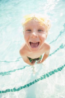 Boy (4-5) posing in swimming pool