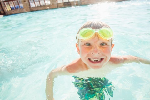 Boy (4-5) posing in swimming pool