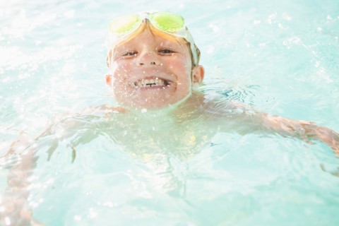 Boy (4-5) swimming in swimming pool