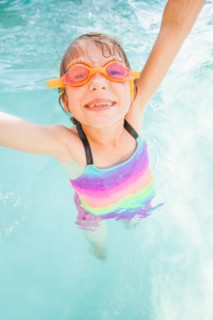 Girl (8-9) playing in swimming pool