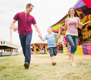 Happy Family and son (4-5) in amusement park