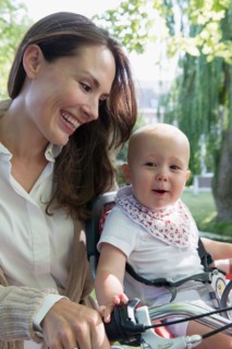 Mother with her baby daughter (12-17 months) on bicycle