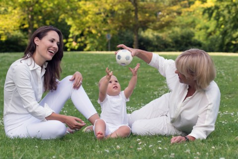 Three generation family playing in park