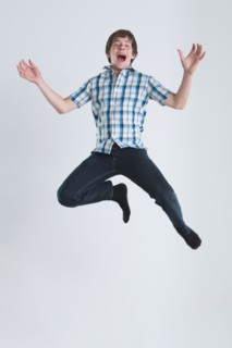 Studio Shot of teenage boy (14-15) jumping