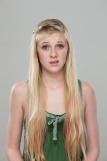 Portrait of teenage girl (14-15) making a face