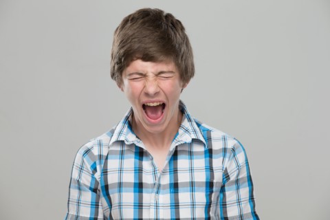 Portrait of teenage boy (14-15) shouting