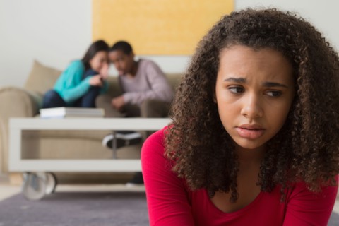 Girl (12-13) crying while two teenagers (14-15,16-17) whispering behind her