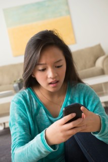 Portrait of teenage girl (16-17) with smartphone