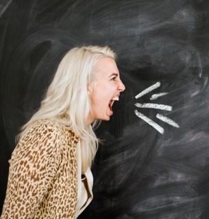 Studio portrait of young woman shouting