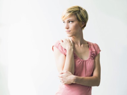 Young woman looking away, studio shot