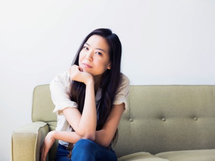 Young woman sitting on sofa