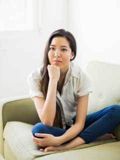 Portrait of woman sitting on sofa