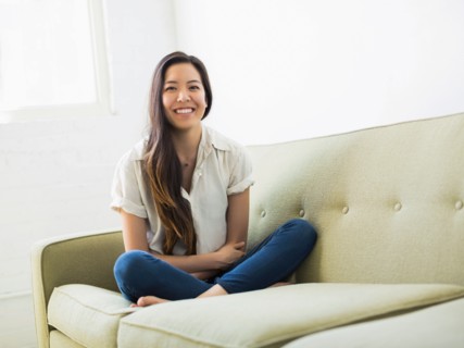 Portrait of woman sitting on sofa