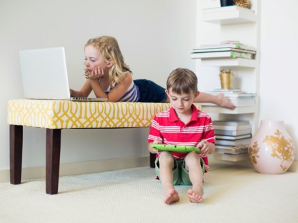 Kids (4-5, 6-7) using laptop and digital tablet indoors