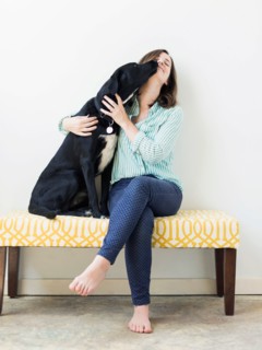 Dog licking woman on face