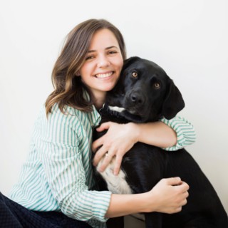 Portrait of woman with black dog