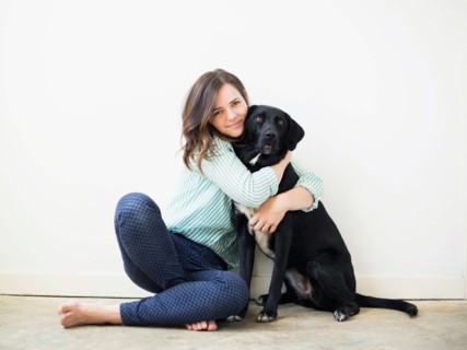 Portrait of woman with black dog