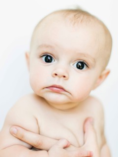 Baby boy (6-11 months) held by adult
