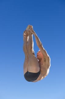 Athletic swimmer jumping.