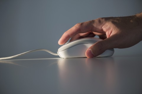 Studio shot of hand using computer mouse.