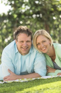 Couple lying on grass.