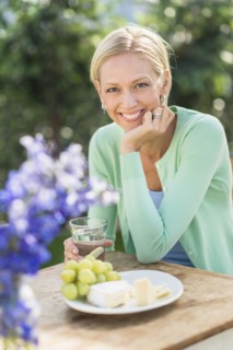 Woman sitting at table outdoors.
