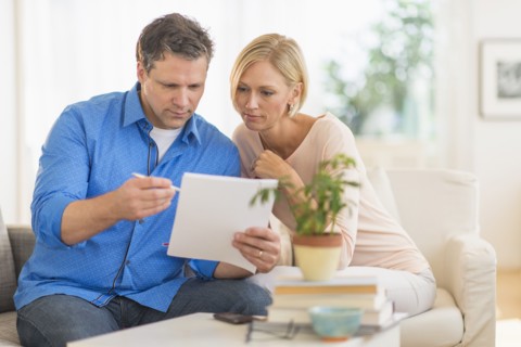 Couple doing paperwork at home.