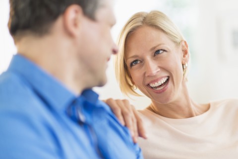 Couple relaxing, focus on woman.