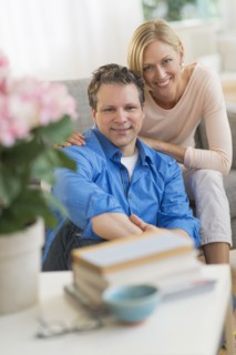 Portrait of couple sitting on sofa.