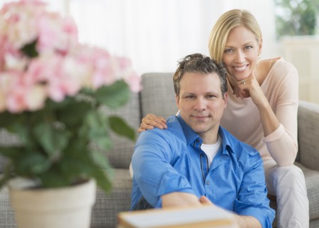 Portrait of couple sitting on sofa.