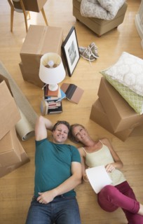 Couple lying on floor of new home.