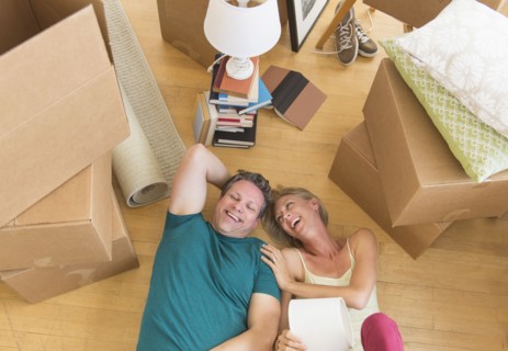 Couple lying on floor of new home.