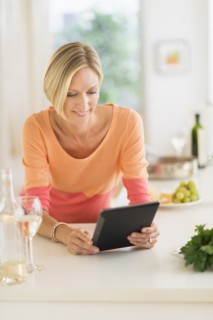 Woman using tablet pc at home.