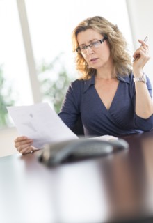 Business woman reading document.