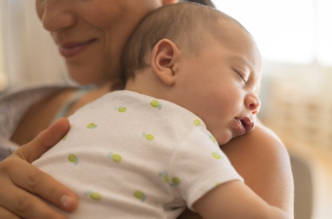 Mother holding baby (2-5 months).