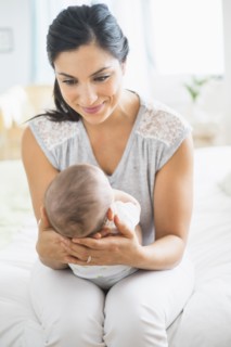Mother playing with baby (2-5 months).