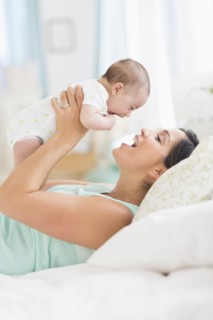 Mother playing with baby (2-5 months).