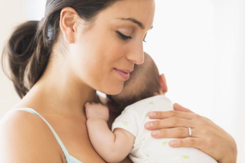 Mother holding baby boy (2-5 months).