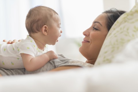 Mother playing with baby boy (2-5 months).