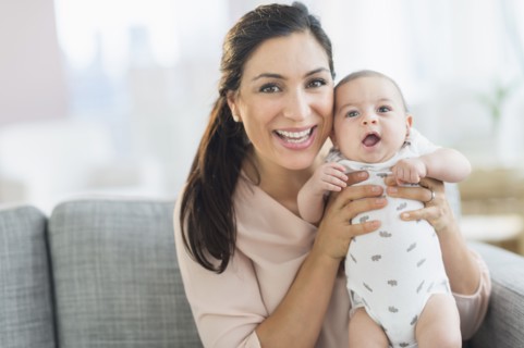 Mother holding baby boy (2-5 months).