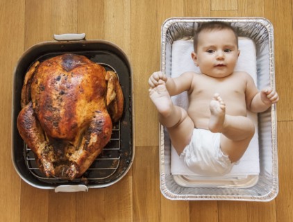 Baked turkey and baby girl (2-5 months) in baking dish.