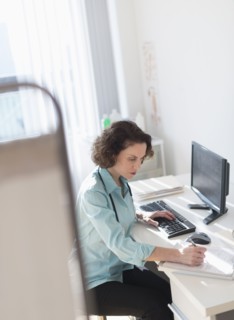 Female doctor doing notes.