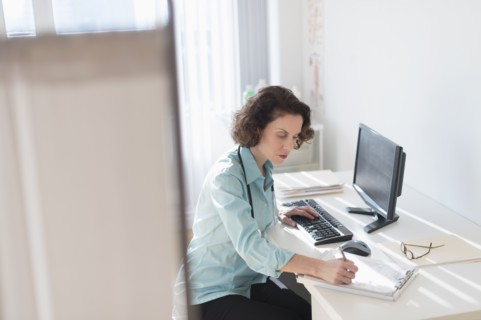 Female doctor doing notes.