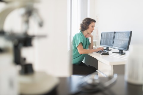 Female technician working on computer.