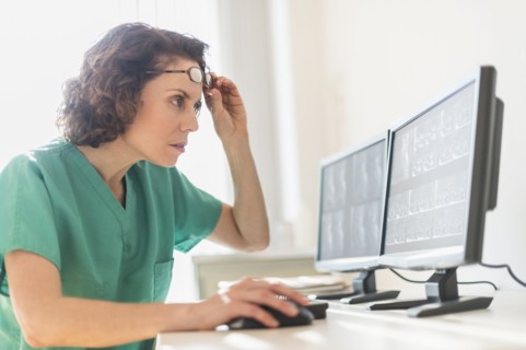 Female technician working on computer.