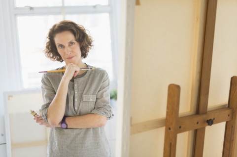 Portrait of female painter in studio.